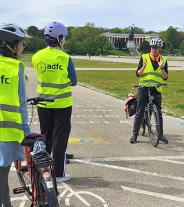 trainer auf fahrrad erklärt teilnehmern die nächste übung